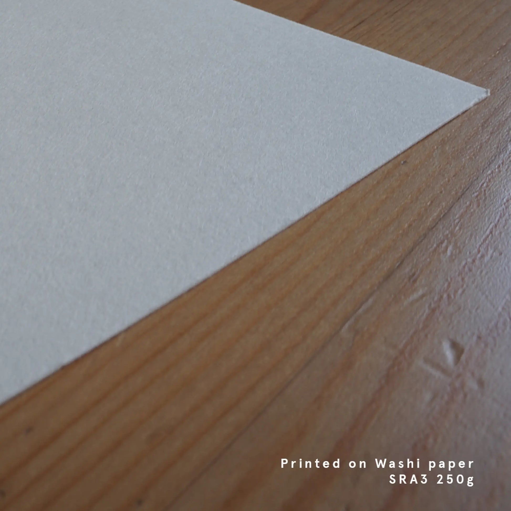 Macro perspective of a blank SRA3 heavy-weight Japanese washi paper corner, emphasizing the authentic fibrous texture used for art reproduction.